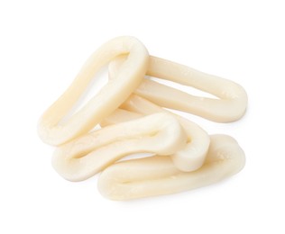 Photo of Many uncooked squid rings isolated on white, top view