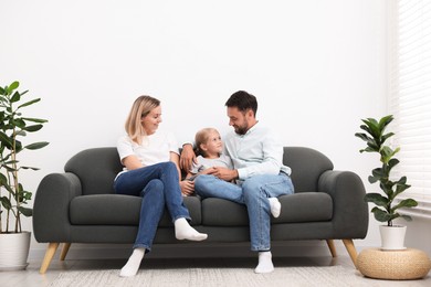 Photo of Happy family spending time together on sofa at home
