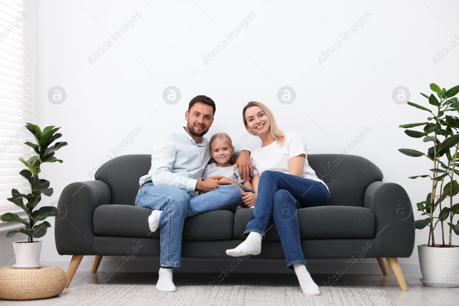 Photo of Happy family spending time together on sofa at home