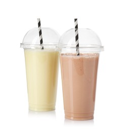 Photo of Milkshakes of different flavors in plastic cups isolated on white