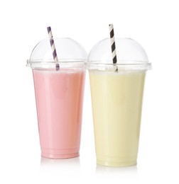 Photo of Milkshakes of different flavors in plastic cups isolated on white