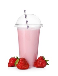 Photo of Tasty strawberry milkshake in plastic cup and fresh fruits isolated on white