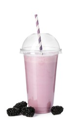 Photo of Tasty blackberry milkshake in plastic cup and fresh berries isolated on white