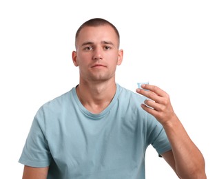 Photo of Man with bottle cap of mouthwash on white background