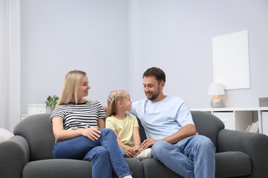 Photo of Happy family spending time together on sofa at home