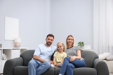 Photo of Happy family spending time together on sofa at home