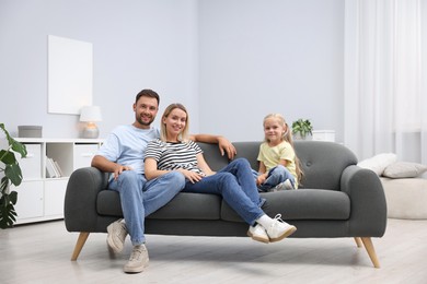 Photo of Happy family spending time together on sofa at home