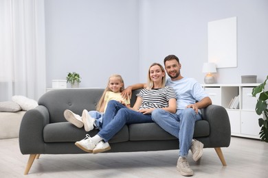 Photo of Happy family spending time together on sofa at home