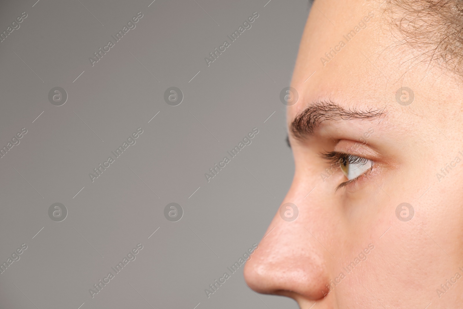 Photo of Woman with beautiful eyes on light grey background, closeup. Space for text