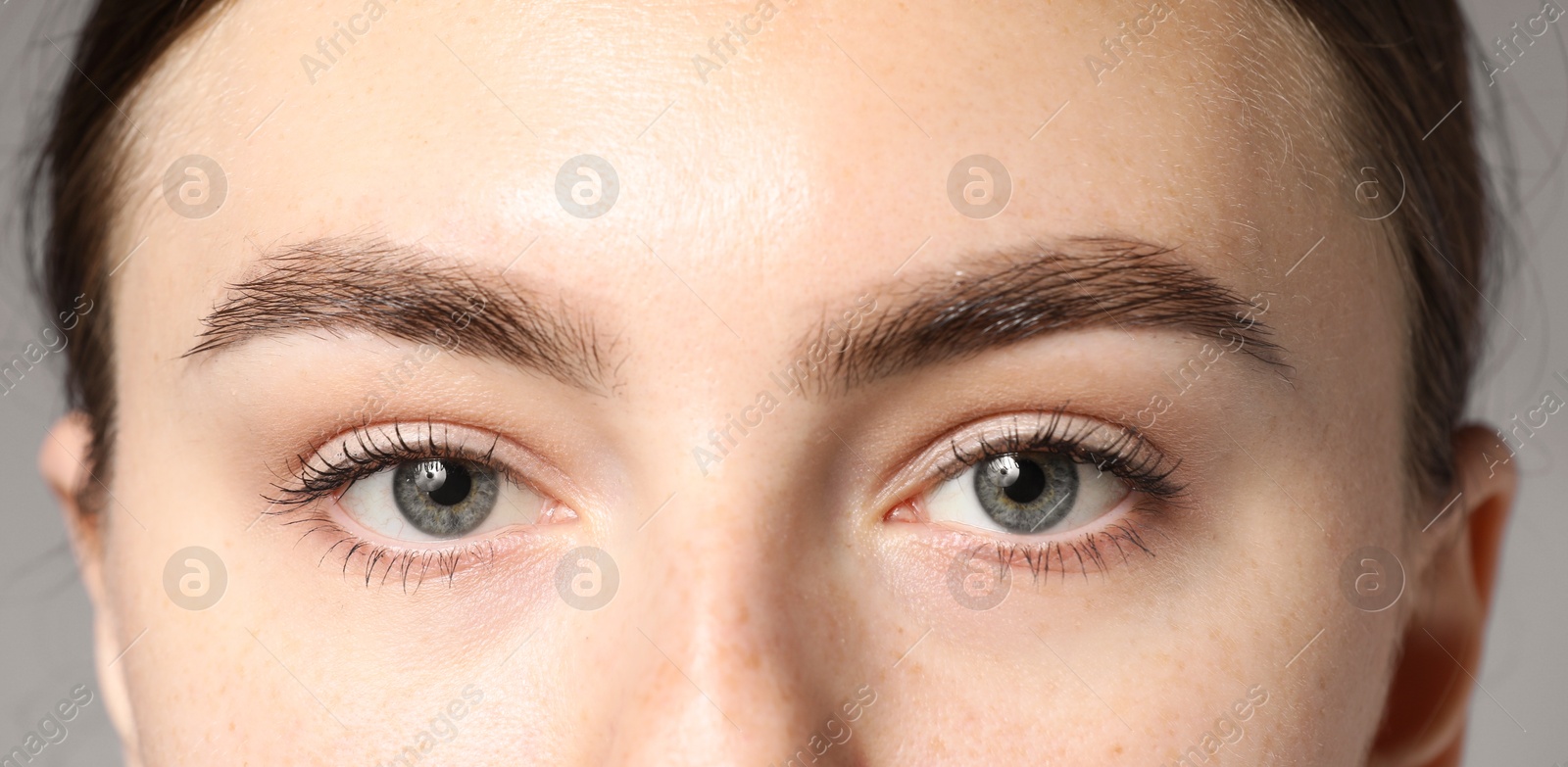 Photo of Woman with beautiful eyes on light grey background, closeup