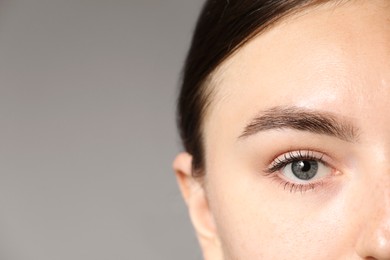 Photo of Woman with beautiful eyes on light grey background, closeup. Space for text