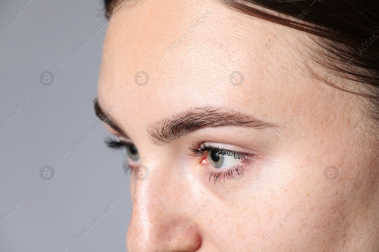 Photo of Woman with beautiful eyes on light grey background, closeup