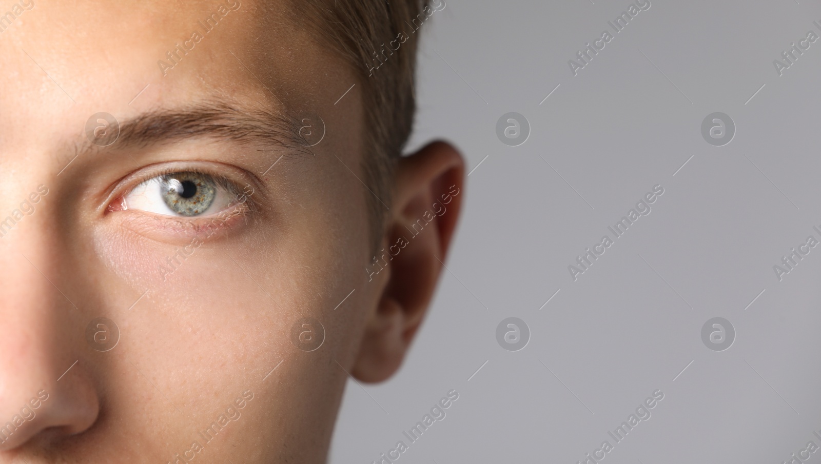 Photo of Man with beautiful eyes on light grey background, closeup. Space for text