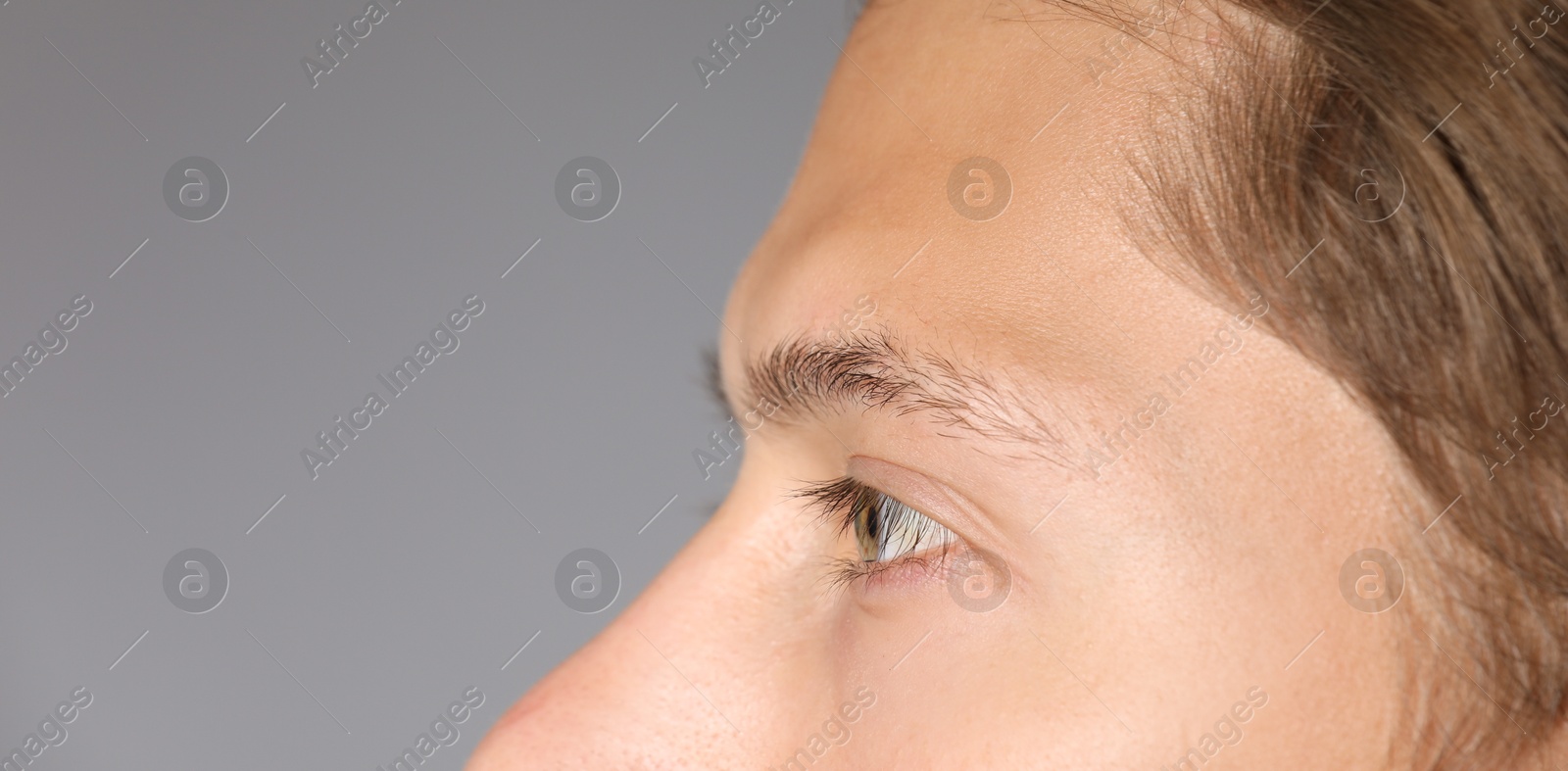 Photo of Man with beautiful eyes on light grey background, closeup. Space for text