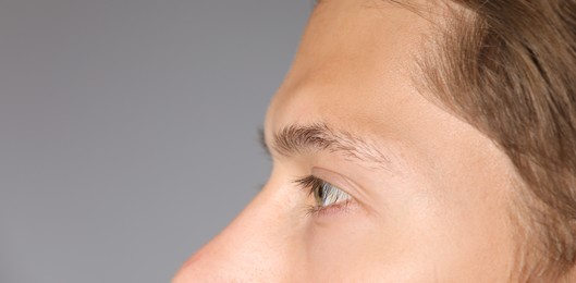 Photo of Man with beautiful eyes on light grey background, closeup. Space for text