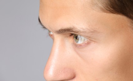 Photo of Man with beautiful eyes on light grey background, closeup
