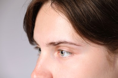 Photo of Woman with beautiful eyes on light grey background, closeup