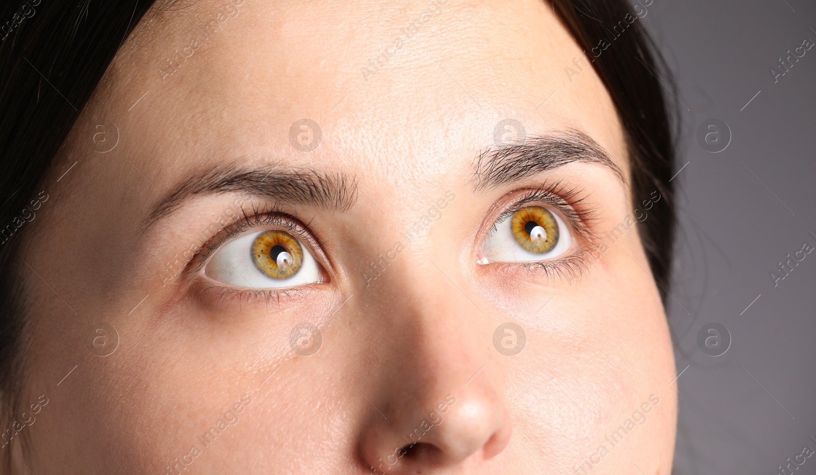 Photo of Woman with beautiful eyes on light grey background, closeup