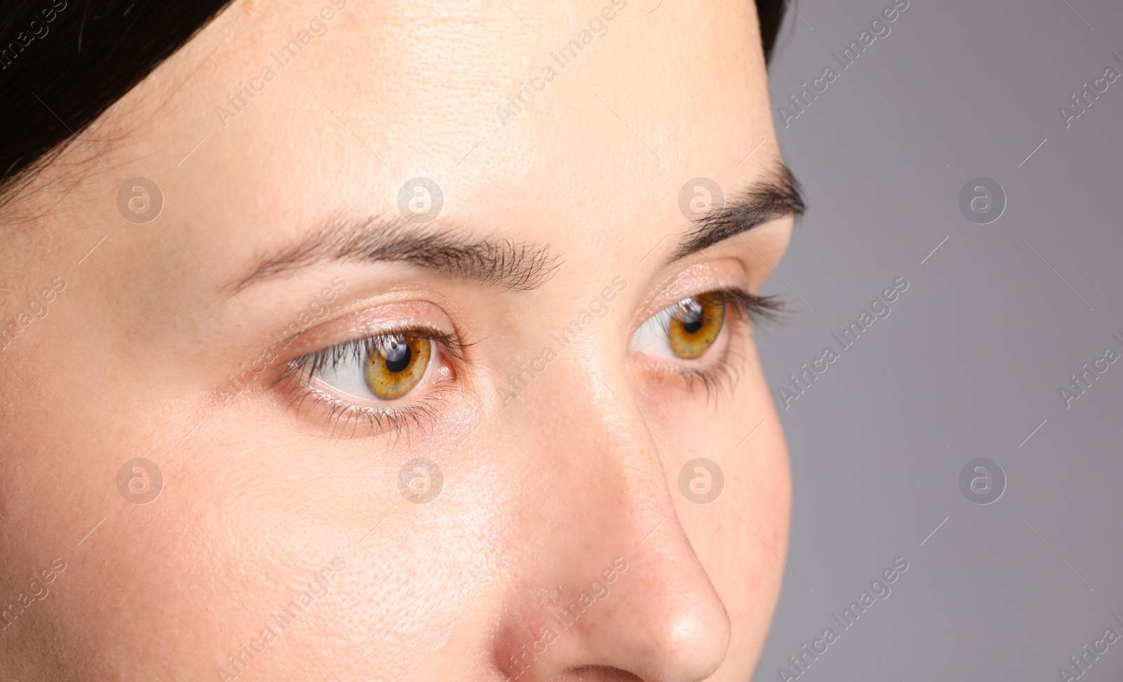 Photo of Woman with beautiful eyes on light grey background, closeup