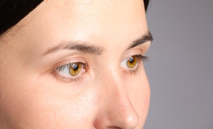 Photo of Woman with beautiful eyes on light grey background, closeup
