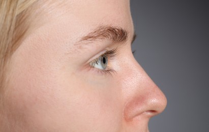Photo of Woman with beautiful eyes on light grey background, closeup