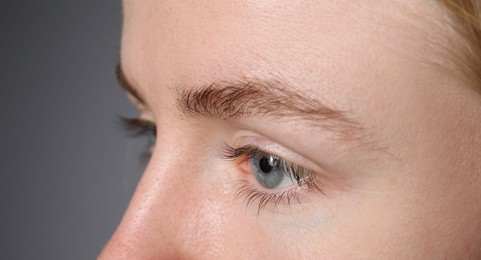 Photo of Woman with beautiful eyes on light grey background, closeup