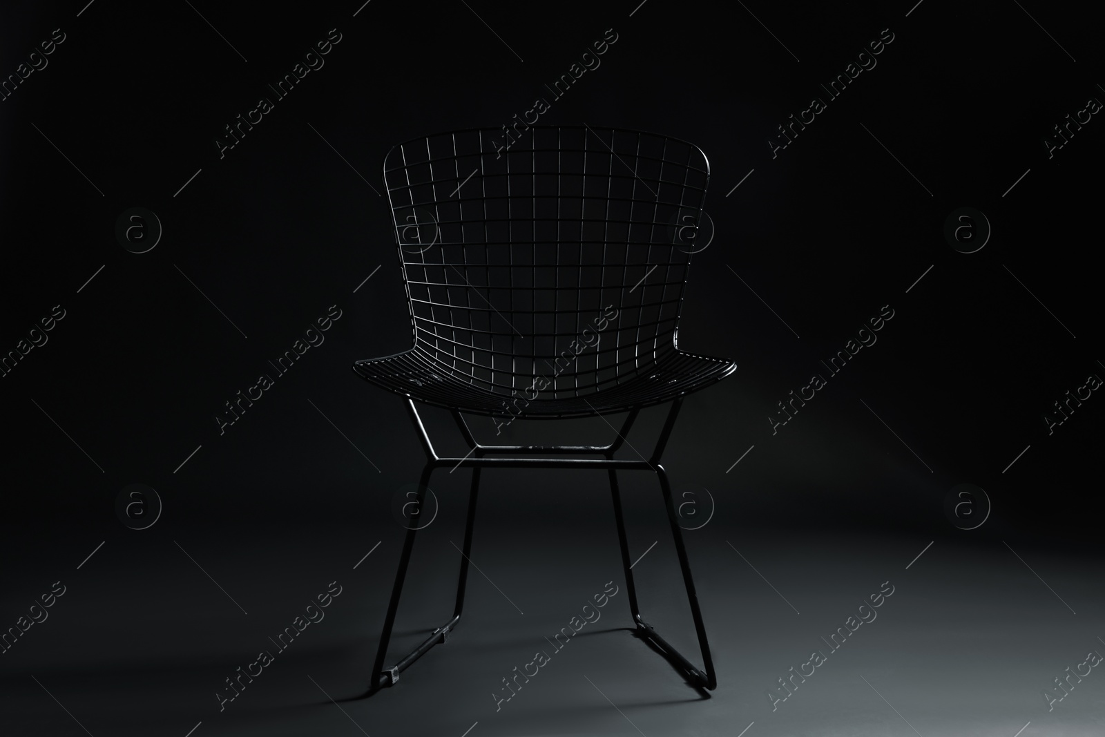 Photo of Stylish chair on black background. Used stuff