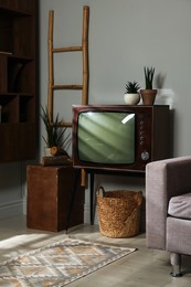 Photo of Retro TV set and other used stuff indoors