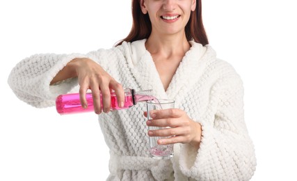 Photo of Woman rinsing mouth with mouthwash on white background, closeup