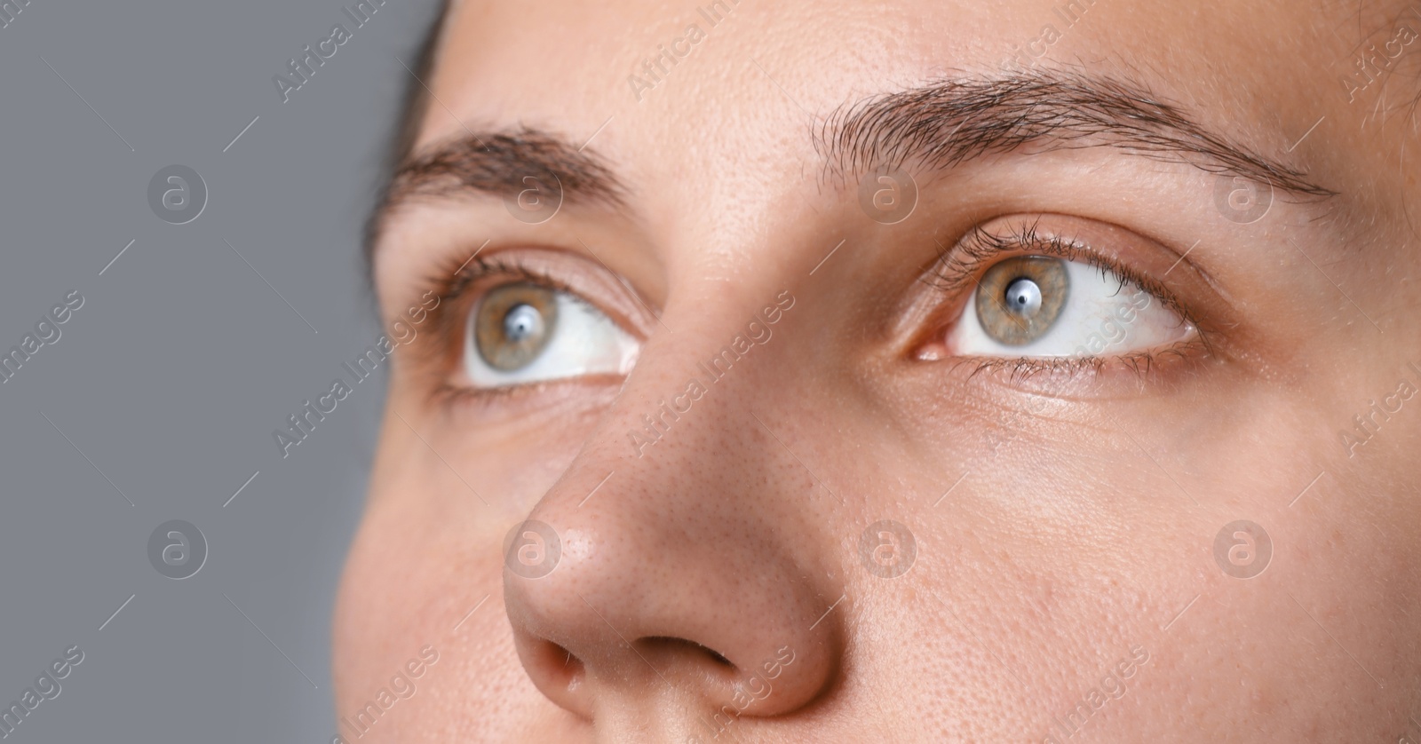 Photo of Woman with beautiful eyes on light grey background, closeup
