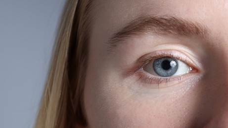 Photo of Woman with beautiful eyes on light grey background, closeup