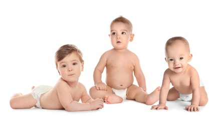 Image of Adorable babies in diapers on white background