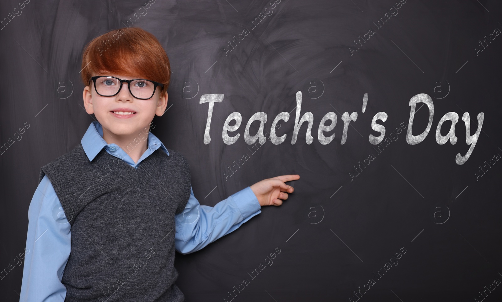 Image of Happy Teacher's Day. Cute little boy with eyeglasses near blackboard