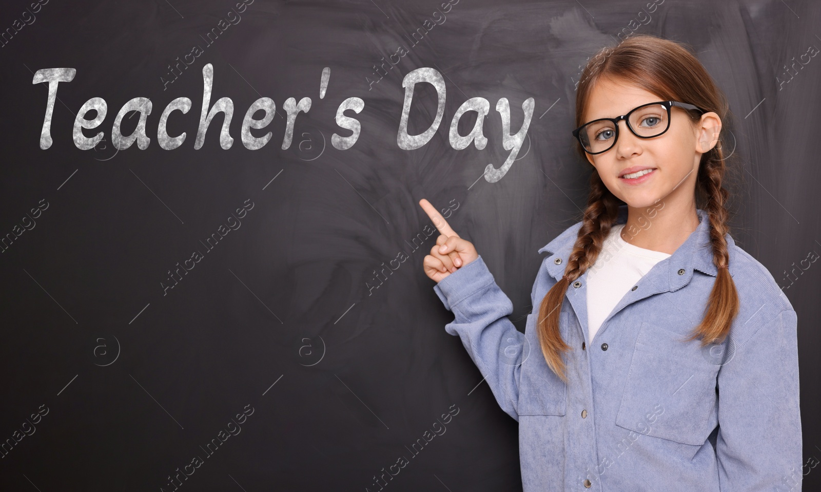 Happy Teacher's Day. Cute little girl with eyeglasses near blackboard Image of Happy Teacher's Day. Cute little girl with eyeglasses near blackboard
