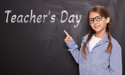 Image of Happy Teacher's Day. Cute little girl with eyeglasses near blackboard