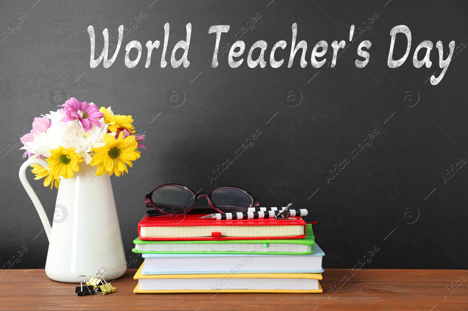Image of Happy Teacher's Day greeting card with flowers and text on blackboard