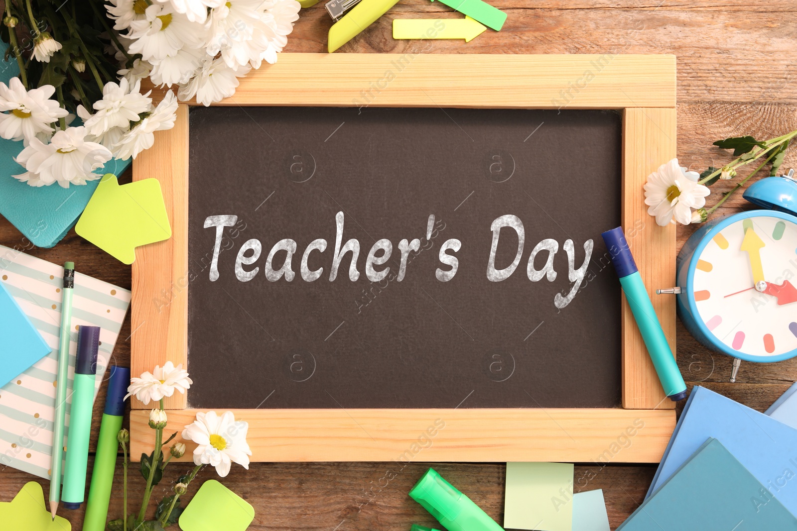 Image of Happy Teacher's Day greeting card with flowers and text on small chalkboard