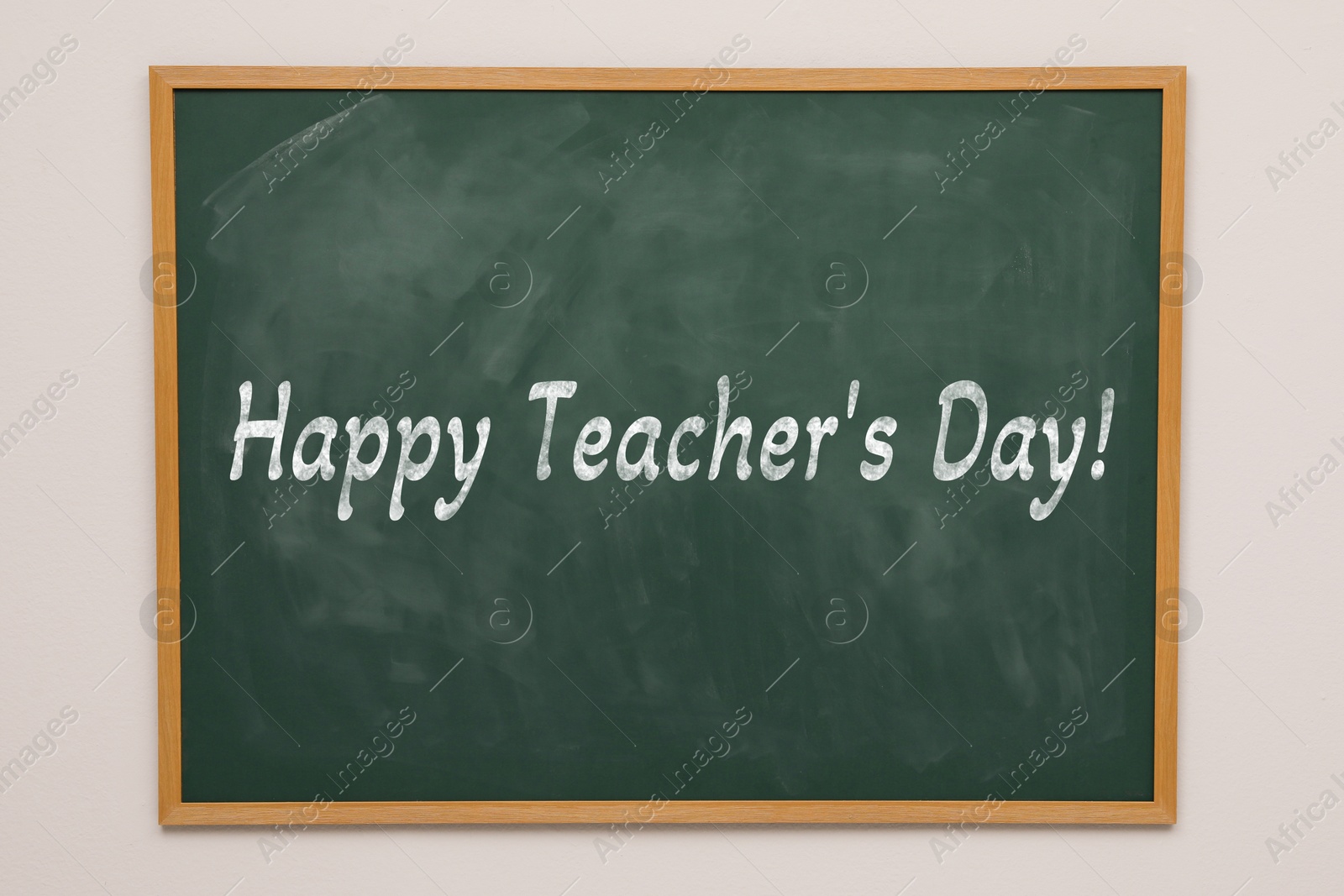 Image of Happy Teacher's Day greeting card. Text on green chalkboard
