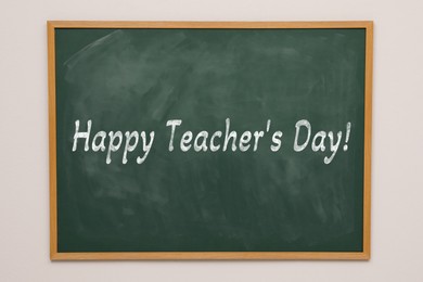 Image of Happy Teacher's Day greeting card. Text on green chalkboard