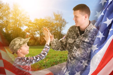 Image of Military man giving his son high five outdoors, double exposure with national flag of USA