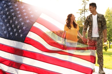 Image of Military man and his girlfriend outdoors, double exposure with national flag of USA