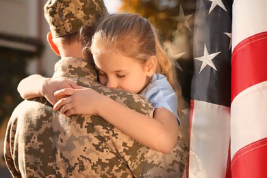 Image of Military man and his daughter outdoors, double exposure with national flag of USA