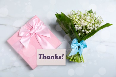 Image of Thanks card, gift box and flowers on white background, bokeh effect