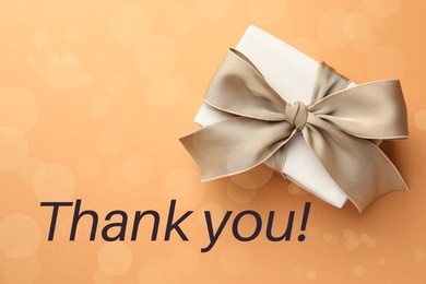 Image of Thank you card design with gift boxes on pale orange background, bokeh effect
