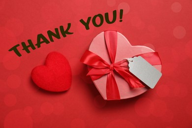 Image of Thank you card design with heart-shaped gift box on red background. Bokeh effect