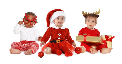 Image of Cute babies in Christmas clothes on white background