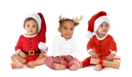 Image of Cute babies in Christmas clothes on white background