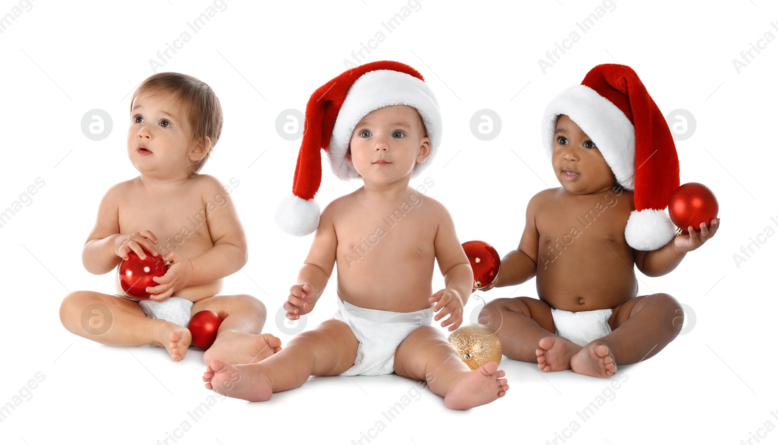 Cute babies in Christmas balls and Santa hats on white background Image of Cute babies in Christmas balls and Santa hats on white background
