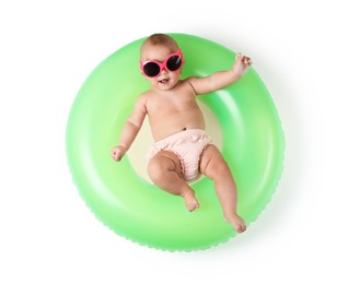 Photo of Cute little baby in sunglasses with inflatable ring on white background, top view