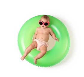 Photo of Cute little baby in sunglasses with inflatable ring on white background, top view